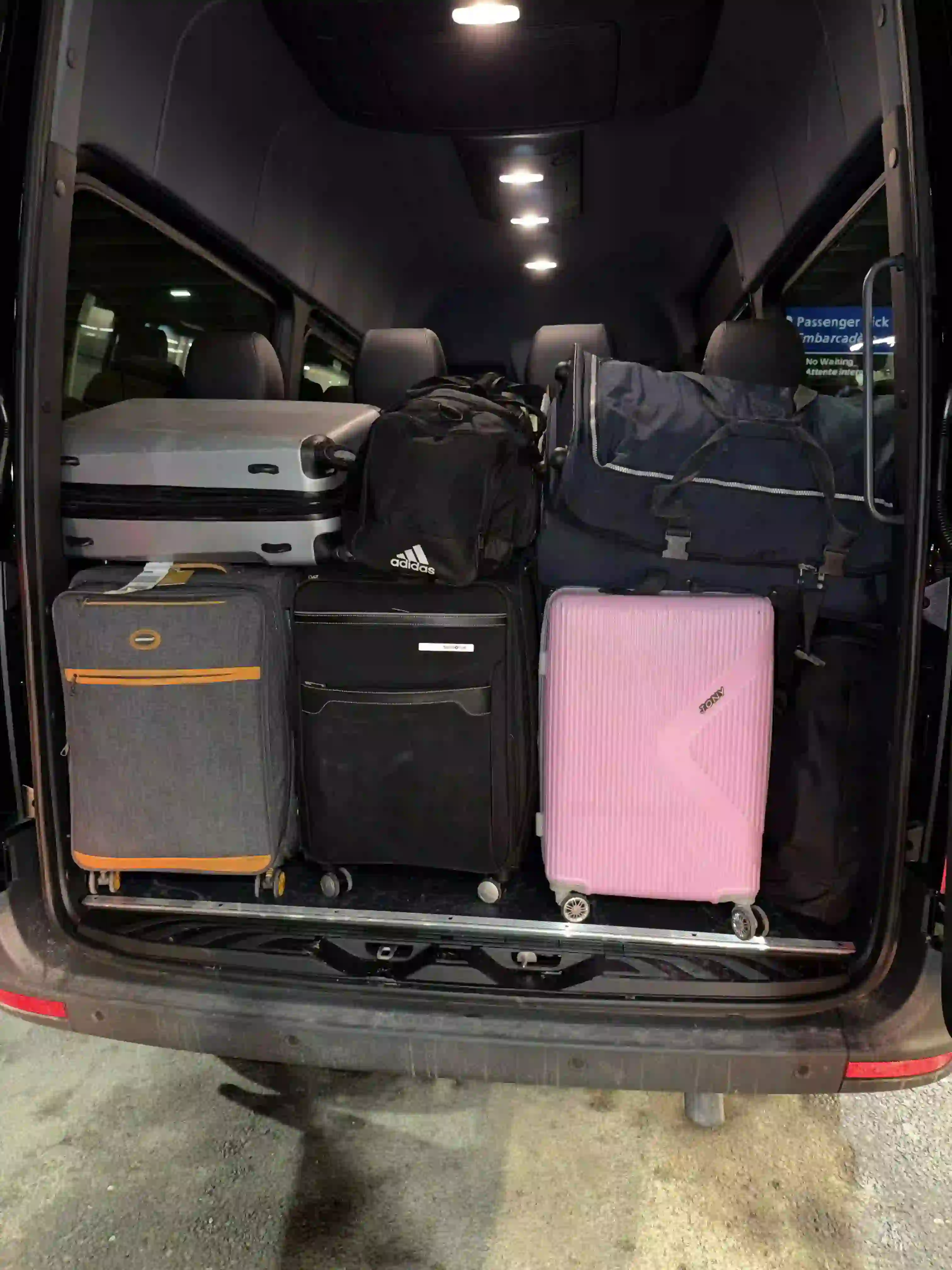 Driver loading luggage into vehicle